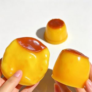 Hands squeezing crispy crunch building block pudding squishy toy